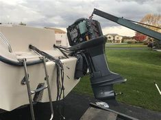 a boat is parked in the grass with it's front end lifted up to the ground