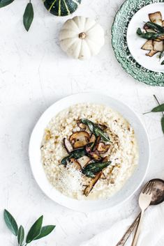 a white bowl filled with rice and vegetables on top of a table next to silverware