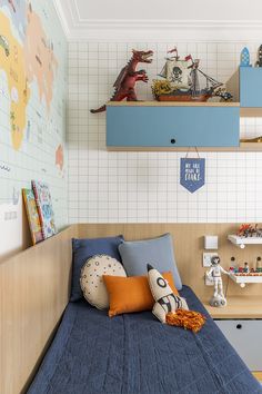 a child's bedroom with blue bedding and toy animals on shelves above the bed