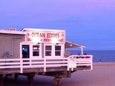 an ocean edge restaurant on the beach at dusk