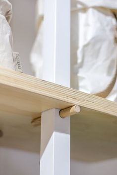 a bag is sitting on top of a wooden shelf