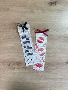 two bookmarks with the words love and kisses written on them, tied to each other