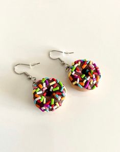 I love donuts so I made my favorite dessert into earrings! So come on now and order a pair of super cute donut earrings! Everyone will ask you about your earrings and you'll get lots of compliments, trust me I know!! This listing includes one pair of donut earrings with multicolored sprinkles handcrafted in polymer clay. Please allow for slight differences in the final product. It is very difficult to replicate each pair of earrings as these are handcrafted. Thank you for understanding. Question Donut Earrings, Earrings Food, Donuts Earrings, Easter Earrings, Cute Donuts, Favorite Dessert, Food Earrings, Easter Peeps, Beignets