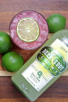 a bottle of deodorant next to some limes on a cutting board