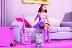 a barbie doll sitting on top of a couch next to a small dog and guitar