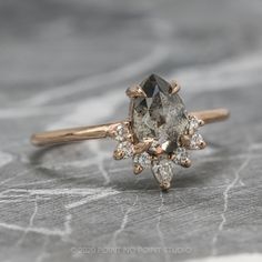 a close up of a diamond ring on a table