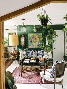 a living room filled with furniture and lots of plants