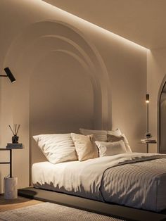 a large bed sitting in a bedroom next to a wall with arches on the walls