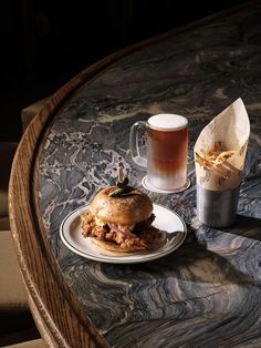 a table topped with a plate of food next to a cup of coffee