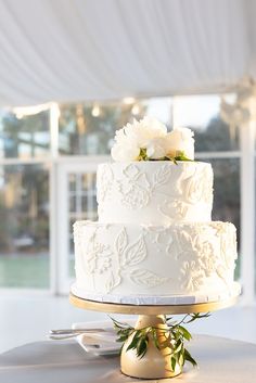 a white wedding cake sitting on top of a table