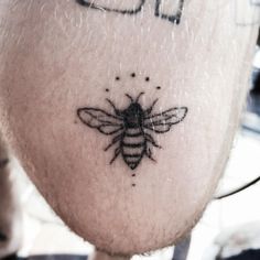 a close up of a person's head with a tattoo on it