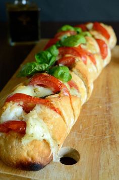 a long sandwich on a wooden cutting board