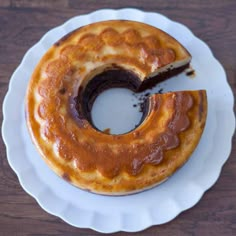 a bundt cake on a white plate with a slice missing