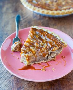 a piece of pie sitting on top of a pink plate