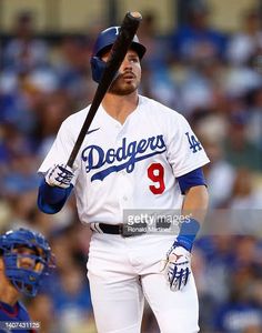 los angeles dodgers baseball player holding a bat during a game against the st louis cardinals