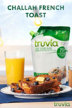 a bag of truvia next to some blueberries and bread on a plate