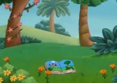 the book is laying on the grass in front of some trees and flowers, with an open book lying on it's side