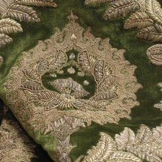 green and gold brocaded fabric with large leaves