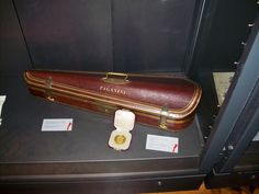 an old suitcase is on display in a case