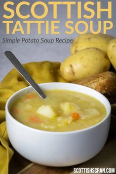 a white bowl filled with soup next to potatoes