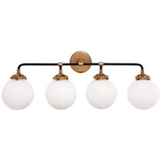 three light bathroom fixture with white glass globes on an antique brass finish wall mount