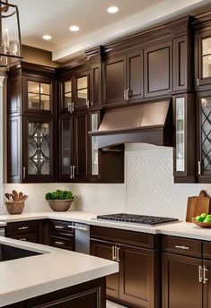 a kitchen with dark wood cabinets and white counter tops is pictured in this image from the front view