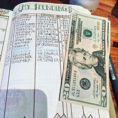 a stack of money sitting on top of a notebook