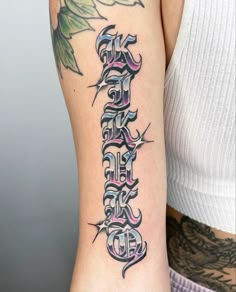 a woman with a tattoo on her arm has the word faith written in cursive letters