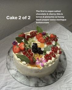 a cake with berries, raspberries and other toppings