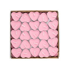 pink heart shaped candles in a cardboard box