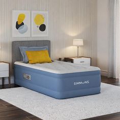 a blue mattress sitting on top of a white bed