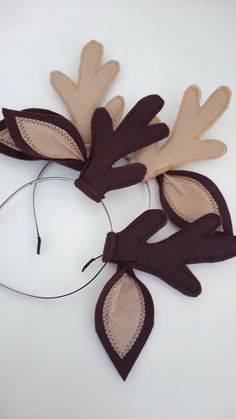 the headband is made out of felt and has brown leaves on it, along with a cord