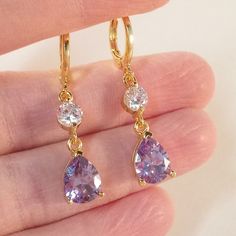 Earrings Beautiful Women's Classic Elegant Design Amethyst Purple Dangle Earrings 18k Yellow Gold Filled With Large Sparkling Pear Teardrop Water Drop Shape Amethyst Purple + Smaller Clear White Round Simulated Diamond Topaz Zircon Gemstones. Top Quality, High Polished Shine, Brand New, Never Been Worn. Lead, Nickel Free. These Earrings Sparkle. Perfect Jewelry For Any Day, Special Occasion Gift Anniversary Banquet Dating Birthday Promise Prom Dance Holiday Party Christmas Stocking For Yourself Purple Prom Earrings, Purple Quince Jewelry, Gold Purple Jewelry, Dangly Purple Earrings, Purple And Gold Earrings, Gold And Purple Jewelry, Purple And Gold Jewelry, Light Purple Jewelry, Alexandrite Earrings