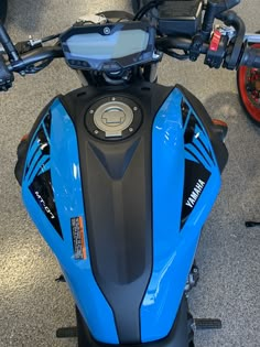 the front end of a blue and black motorcycle