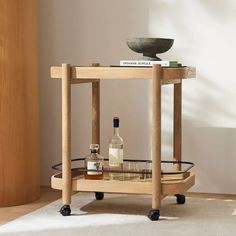 a wooden table with a glass shelf on it and bottles sitting on top of it