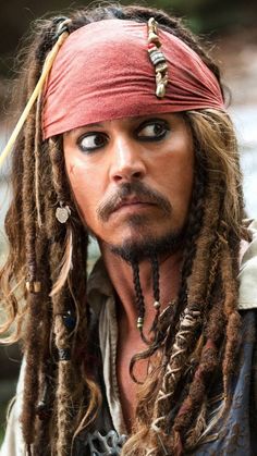 a close up of a person with dreadlocks wearing a pirate hat and eye makeup