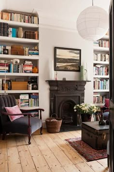 a living room filled with lots of books and furniture