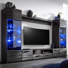 a modern entertainment center with blue lights on the side and glass doors, in a living room