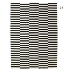 a black and white striped rug with hearts on the bottom right corner, in front of a white background