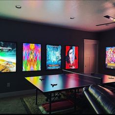 a room with ping pong tables and several movie posters on the wall