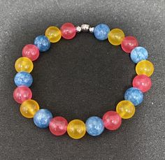 Genuine jade and aquamarine beads come together to create the Pansexual Pride flag. Beads are 8mm. Bracelet is 6 inches around and made with crystal stretch elastic cord. Pansexual Bracelet, Make Clay Beads, Flag Beads, Pansexual Pride, Purple Jade, Aquamarine Beads, Butterfly Charm, Pride Flag, Bead Jewelry