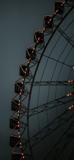 a large ferris wheel with lights on it's sides