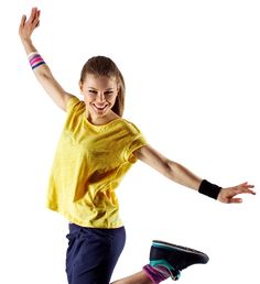 a girl is jumping in the air with her arms outstretched