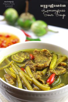 a white bowl filled with green beans and meat