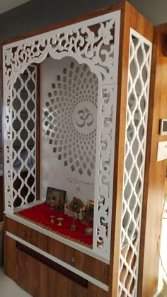 an intricately designed display case with pictures and cards on the front, in a living room