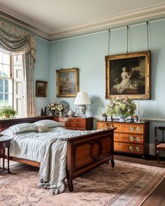 a bedroom with blue walls and antique furniture