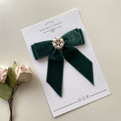 "Make a statement with our enchanting short tail green velvet hair bow, embellished with a shimmering pearl and rhinestone button. Available as a clip, bobble, or barrette, this accessory is a perfect blend of sophistication and sparkle, designed to elevate your style effortlessly. ✨ Key Features: -  Luxe Velvet : Immerse yourself in the velvety softness of our premium green velvet, creating a short tail bow that feels as luxurious as it looks. -  Pearl and Rhinestone Elegance: Adorned with a ra Velvet Bows, Tail Hair, Outdoor Wedding Inspiration, Headband Jewelry, Bow Bow, Bow Hair Clip, Velvet Shorts, Velvet Hair, Green Bows