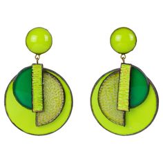 a pair of earrings with green and yellow designs on the front, one is round