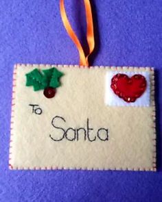 an ornament hanging on a wall with the word to santa written in it