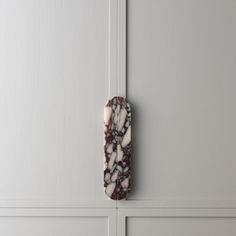 a marble door handle on a white cabinet